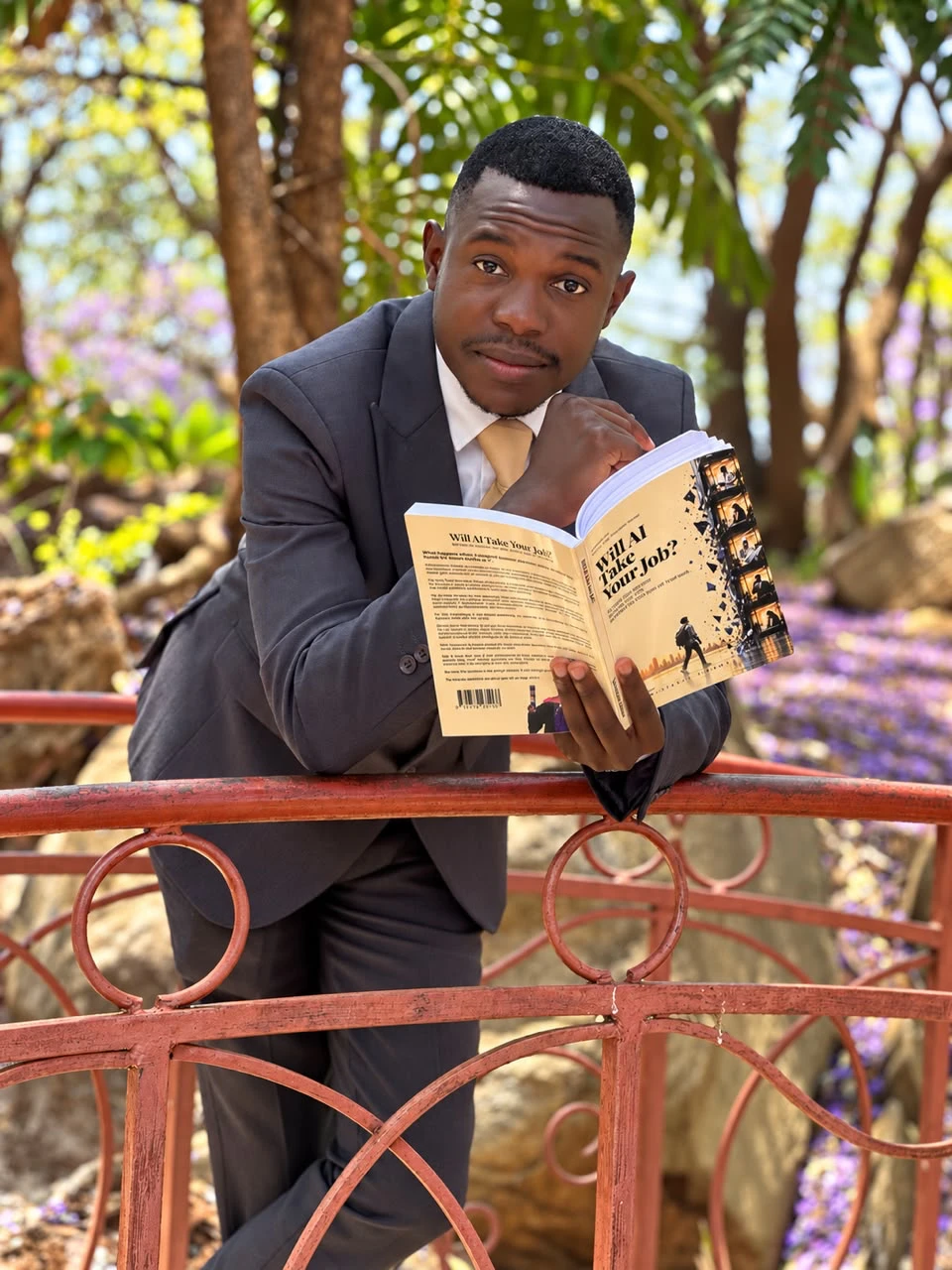 Ngonidzashe Zimbwa reading the book outdoors